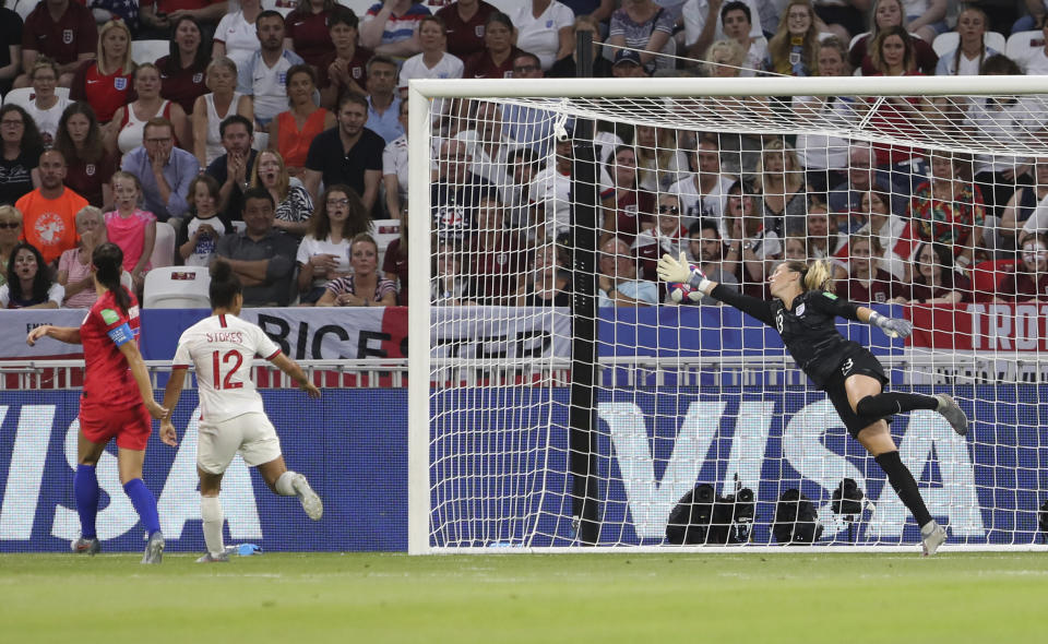 United States' Alex Morgan, left, scores her side's second goal during the Women's World Cup semifinal soccer match between England and the United States, at the Stade de Lyon outside Lyon, France, Tuesday, July 2, 2019. (AP Photo/Laurent Cipriani)