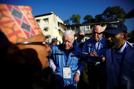 Former U.S. President Jimmy Carter (C), along with his team from the Carter Center, an international poll observation organization, arrives for the ongoing Constituent Assembly election in Bhaktapur, Nepal in this November 19, 2013 file photo. REUTERS/Navesh Chitrakar/Files