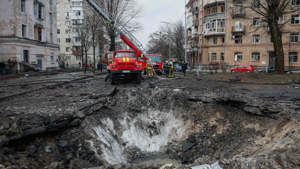 Rescuers work at a site of a building damaged during a Russian missile strike. - Alina Smutko/Reuters