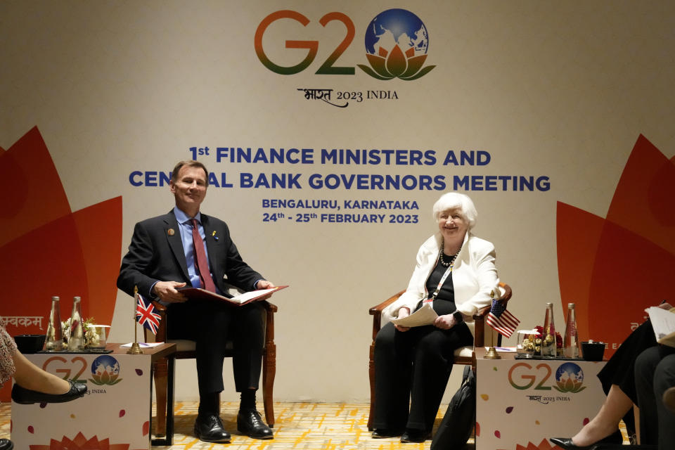 U.S. Treasury Secretary Janet Yellen, right, and Britain's Chancellor of the Exchequer Jeremy Hunt smile as they sit down for their bilateral meeting on the sidelines of G-20 financial conclave on the outskirts of Bengaluru, India, Friday, Feb. 24, 2023. (AP Photo/Aijaz Rahi)