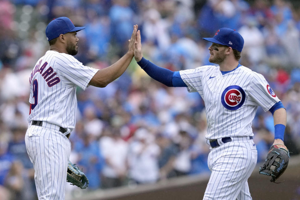 Chicago Cubs' Jeimer Candelario, left, and Ian Happ celebrate after their win over the Atlanta Braves in a baseball game Saturday, Aug. 5, 2023, in Chicago. (AP Photo/Charles Rex Arbogast)