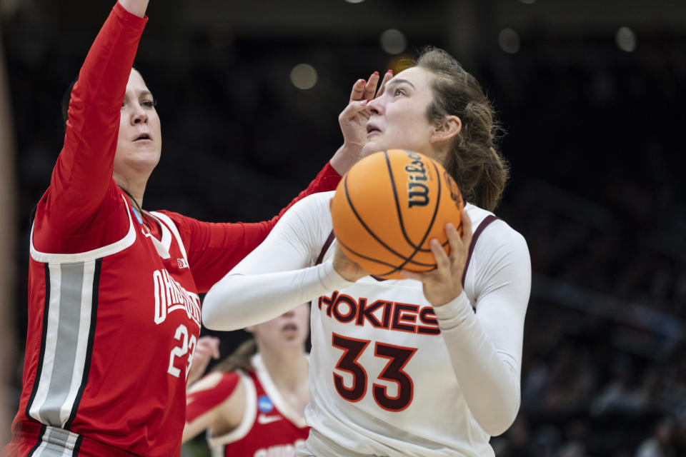 FILE - Virginia Tech center Elizabeth Kitley (33) looks to shoot against Ohio State forward Rebeka Mikulasikova during an Elite 8 college basketball game of the NCAA Tournament, Monday, March 27, 2023, in Seattle. Virginia Tech won 84-74. (AP Photo/Stephen Brashear, File)