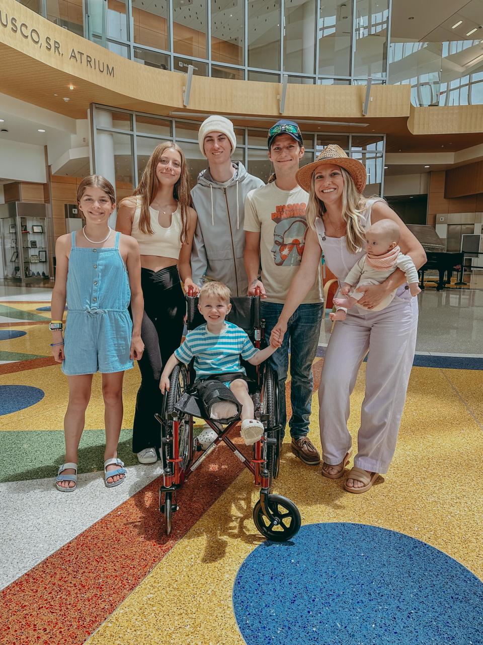 Zeke Clark, center, on discharge day with, back row, from left, Quinn Clark, 11; Chloe DeForrest, 14; Cameron DeForrest, 16; dad Jonathan Clark; mom Maria Clark DeForrest; and Blake Clark, 4 months. Missing from the family photo is Eli Clark, 13.