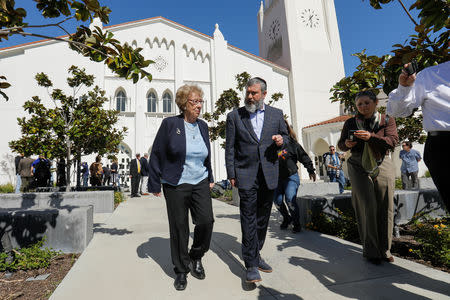 Auschwitz survivor Eva Schloss, stepsister of Holocaust diarist Anne Frank, walks with Chabad Rabbi Reuven Mintz at Newport Harbor High School after speaking with a group of students seen in viral online photos giving Nazi salutes over a swastika made of red cups that sparked outrage in Newport Beach, California, U.S., March 7, 2019. REUTERS/Mike Blake