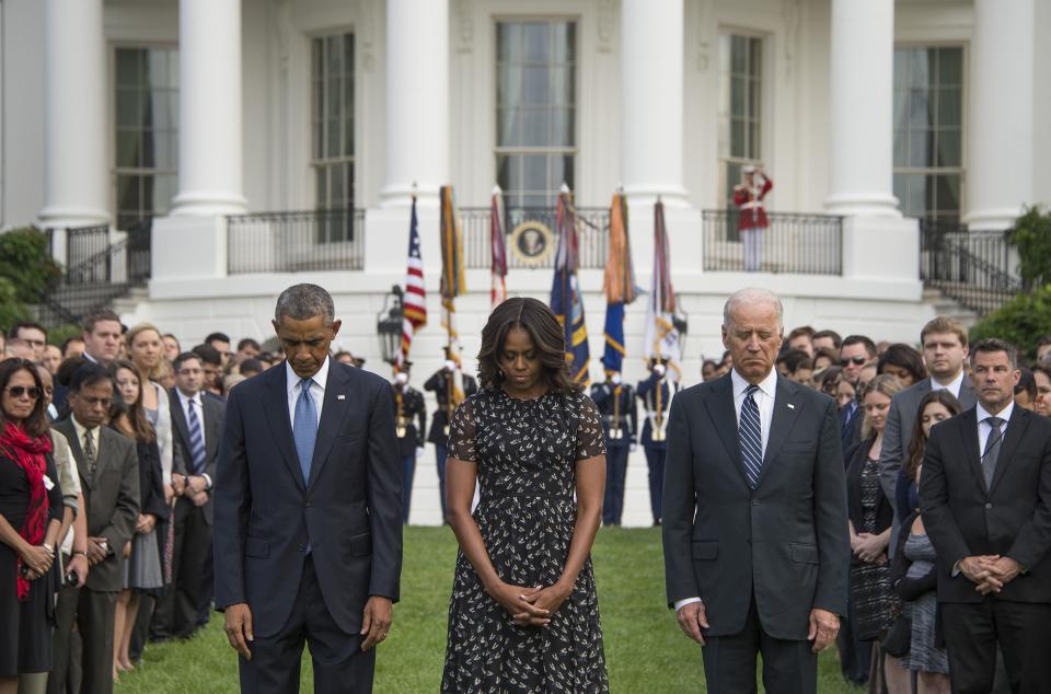 US President Barack Obama (L), First Lady Michelle Obama and Vice President Joe Biden (R) stand for a moment of silence on the South Lawn of the White House in Washington, DC, September 11, 2014, marking the 13th anniversary of the 9/11 attacks on the United States. (Jim Watson/AFP/Getty Images)