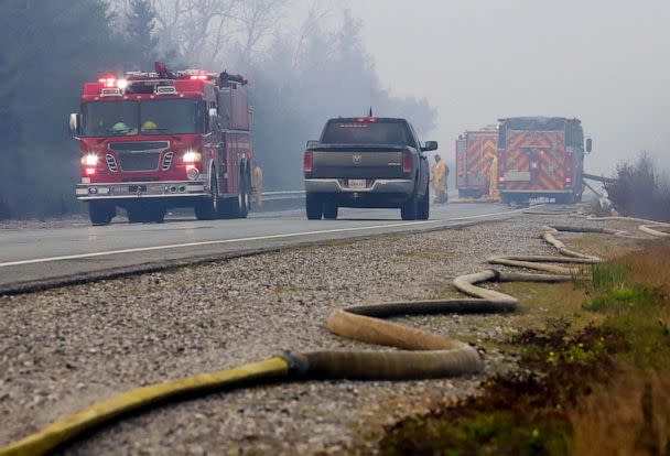 PHOTO: Hose is laid down a road while firefighters tackle the Shelburne wildfires in Shelburne County, Nova Scotia, Canada, June 2, 2023. (Communications Nova Scotia/via Reuters)