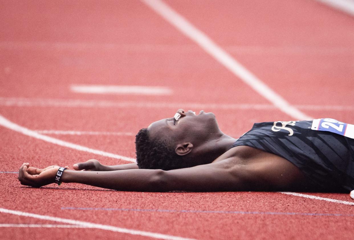 Rouse runner Edwin Rotich rests on the track after finishing the Class 5A 3,200-meter run Friday. The state meet will conclude Saturday with Class 6A competition.