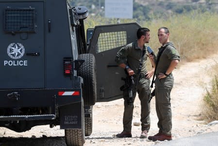 Israeli forces stand guard at the scene of an attack near the Jewish settlement of Dolev in the Israeli-occupied West Bank