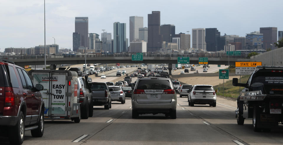 FILE--In this Thursday, July 11, 2019, file photograph, southbound Interstate 25 traffic lanes bog down to a crawl at the interchange with Interstate 70 just north of downtown Denver. To address the complications of an aging road system and a fast-growing population, Coloradoans will decide at the polls on Tuesday, Nov. 5, if the state can permanently keep tax revenue that otherwise would be refunded under limits set by a constitutional amendment called the Taxpayer's Bill of Rights, or TABOR. (AP Photo/David Zalubowski, File)