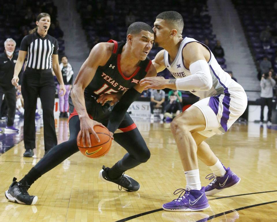 Texas Tech's Kevin McCullar (15) is guarded by Kansas State's Mike McGuirl (00) during a Big 12 Conference game Saturday at Bramlage Coliseum in Manhattan, Kansas.