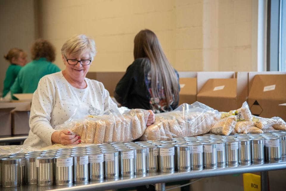 Volunteers at Food Bank of the Southern Tier in Upstate New York packing emergency food boxes and bagging produce for drop and go delivery at Mobile Food Pantry sites and for distribution through regional school districts. Food Banks across the country are changing how they distribute food due to new social distancing guidelines by the CDC.