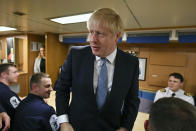 CORRECTING NAME OF BOAT TO HMS VICTORIOUS - Britain's Prime Minister Boris Johnson meets crew members as he tours the nuclear submarine HMS Victorious at the Naval Base in Faslane, Scotland, Monday July 29, 2019. Johnson is expected to announce Monday a 300 million-pound (dollars 371 million US) funding boost to help drive economic growth in Scotland, Wales and Northern Ireland. (Jeff J Mitchell / Pool via AP)