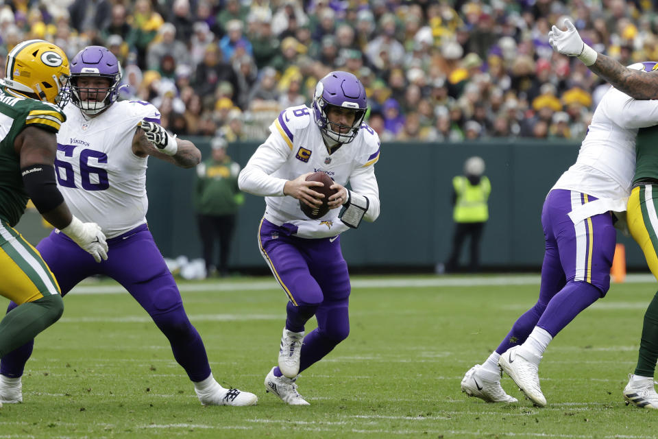 Minnesota Vikings quarterback Kirk Cousins (8) handles the football during the second half of an NFL football game against the Green Bay Packers, Sunday, Oct. 29, 2023, in Green Bay, Wis. Cousins was injured on the play. (AP Photo/Matt Ludtke)