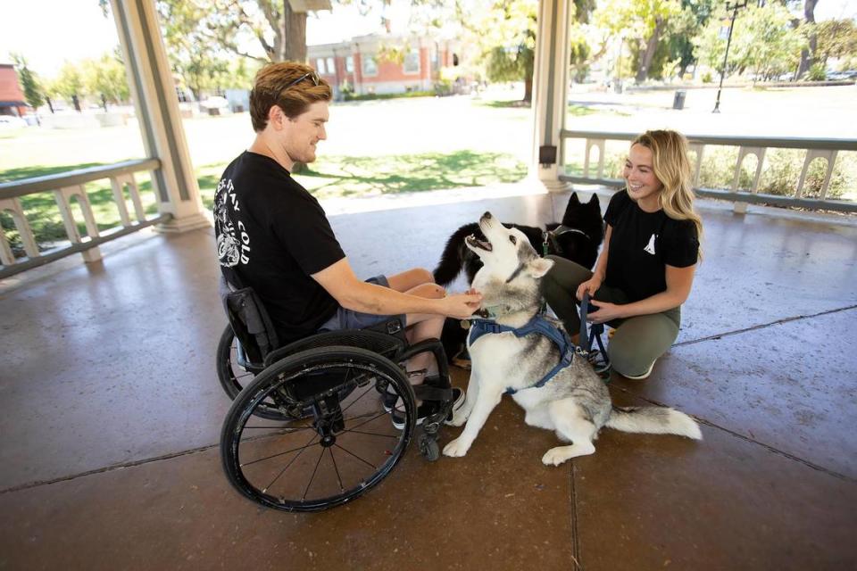 Emily Everett-Nelson, the founder of Atlas Animal Rescue, currently in Paso Robles. Emily rescues dogs locally as well as from slaughterhouses in China and elsewhere overseas to help them find homes. Emily’s husband, Jessy, looks at their first dog, Bolt.