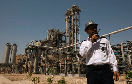 FILE PHOTO: A security personnel stands in front of the Mahshahr petrochemical plant in Khuzestan province,1032 km (641 miles) southwest of Tehran, September 28, 2011. REUTERS/Raheb Homavandi/File Photo