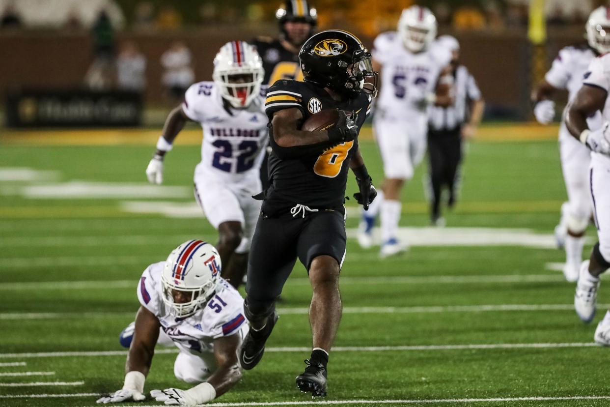 Missouri running back Nathaniel Peat (8) slips a tackle on his way to the end zone during the second half of the Tigers' game against Louisiana Tech on Thursday, Sept. 1, 2022, at Faurot Field.