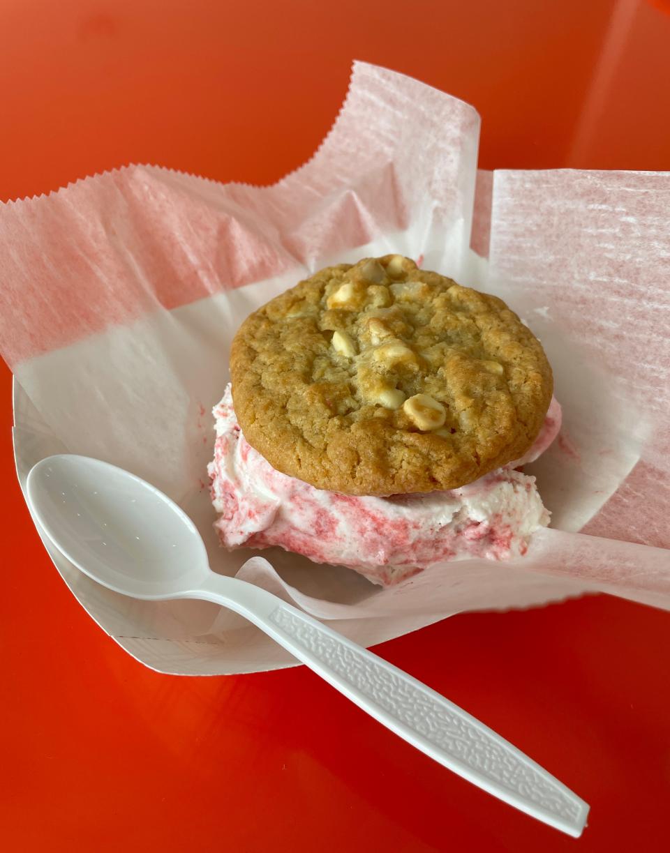 The most popular item at Smoosh Cookies is the ice cream sandwich. Here is one featuring strawberry cheesecake ice cream sandwiched between two white chocolate macadamia nut cookies.