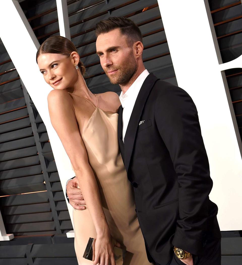 Behati Prinsloo (L) and recording artist Adam Levine attend the 2015 Vanity Fair Oscar Party hosted by Graydon Carter at the Wallis Annenberg Center for the Performing Arts on February 22, 2015 in Beverly Hills, California