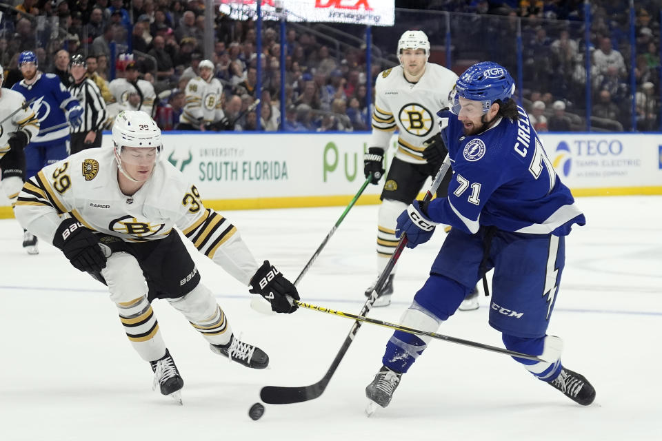 Tampa Bay Lightning center Anthony Cirelli (71) shoots against Boston Bruins center Morgan Geekie (39) during the second period of an NHL hockey game Wednesday, March 27, 2024, in Tampa, Fla. (AP Photo/Chris O'Meara)