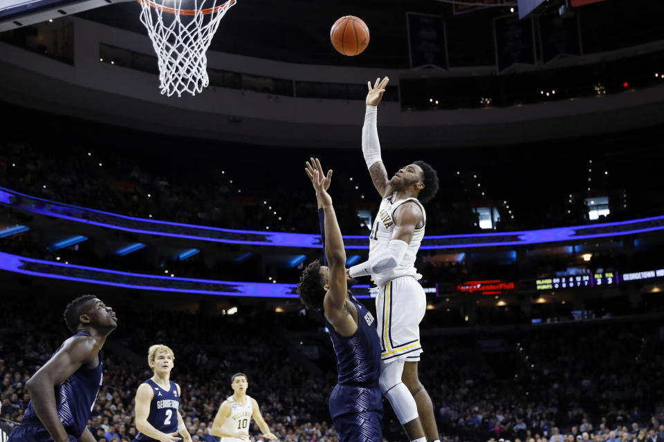 Villanova's Saddiq Bey, right, goes up for a shot against Georgetown's Jagan Mosely during the first half of an NCAA college basketball game, Saturday, Jan. 11, 2020, in Philadelphia. (AP Photo/Matt Slocum)