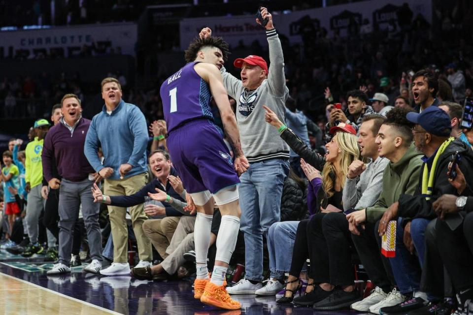 Hornets guard LaMelo Ball celebrates with fans after making a two point basket to solidify a lead as seconds tick away during the game against the Spurs at Spectrum Center on Friday, January 19, 2024. Hornets won, defeating the Spurs, 124-120.