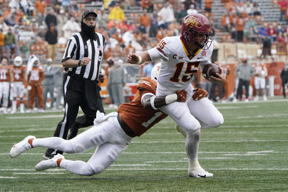 Iowa State quarterback Brock Purdy (15) is taken down on a run by Texas defensive back Chris Adimora (1) during the first half of an NCAA college football game, Friday, Nov. 27, 2020, in Austin, Texas. (AP Photo/Eric Gay)