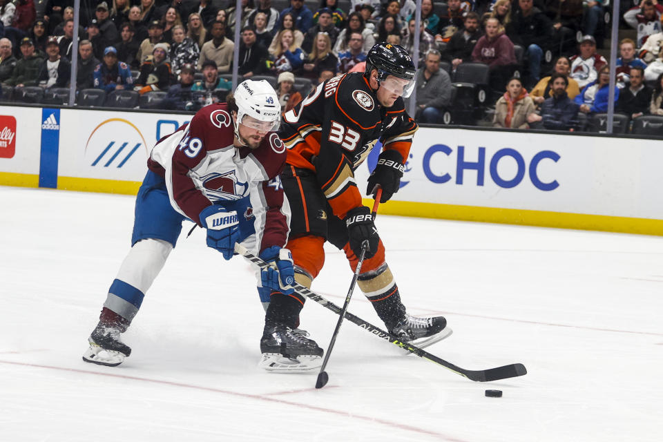 Colorado Avalanche defenseman Samuel Girard, left, and Anaheim Ducks forward Jakob Silfverberg vie for the puck during the second period of an NHL hockey game in Anaheim, Calif., Monday, March 27, 2023. (AP Photo/Ringo H.W. Chiu)