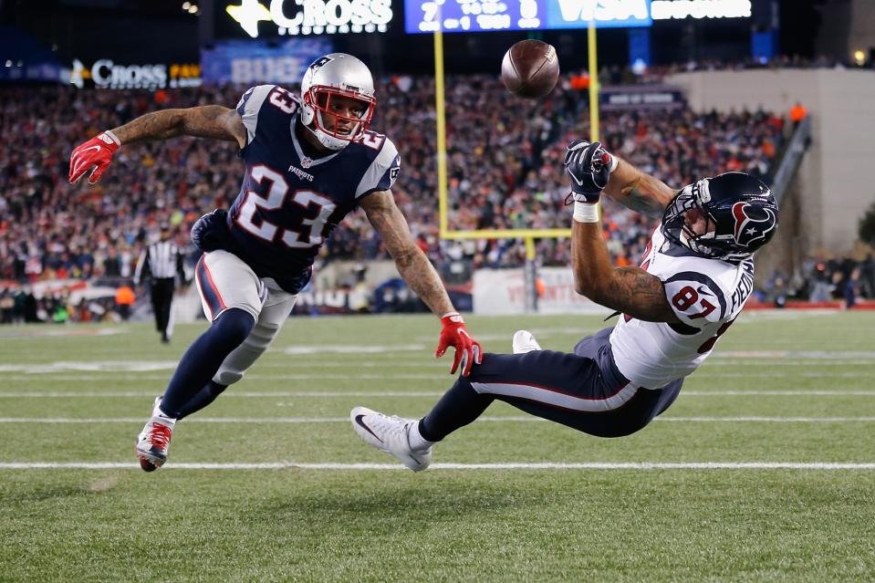 <p>C.J. Fiedorowicz #87 of the Houston Texans misses a catch while under pressure by Patrick Chung #23 of the New England Patriots in the first half during the AFC Divisional Playoff Game at Gillette Stadium on January 14, 2017 in Foxboro, Massachusetts. (Photo by Jim Rogash/Getty Images) </p>