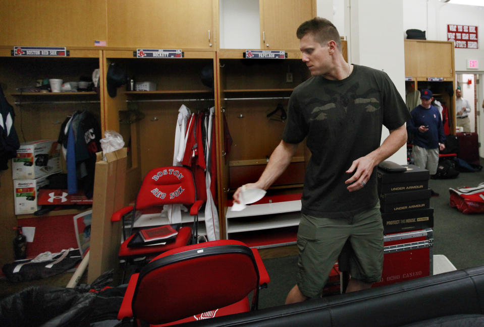 FILE - In this Sept. 29, 2011, file photo, Boston Red Sox closer Jonathan Papelbon cleans out his locker in the clubhouse at Fenway Park in Boston. The Red Sox have fumigated and disinfected their clubhouse at Fenway Park to help fight the flu. Boston manager John Farrell says it has been done a few times while the team has been on the road. The Red Sox have been hit hard by the bug. (AP Photo/Elise Amendola, File)