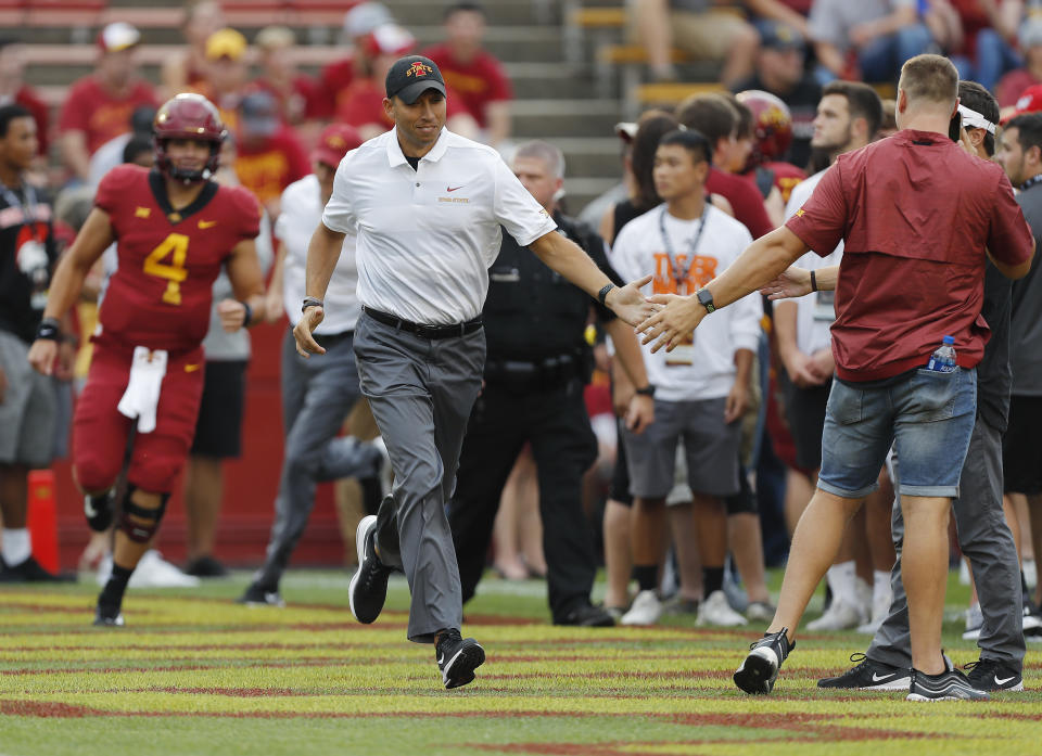 Iowa State head coach Matt Campbell, center, runs on the field and high fives fans before an NCAA college football game against South Dakota State , Saturday, Sept. 1, 2018, in Ames, Iowa. (AP Photo/Matthew Putney)