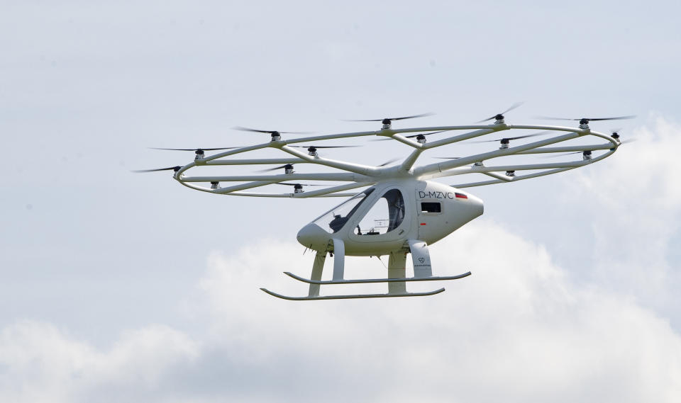 The volocopter, an electrically powered drone taxi, flies near the Mercedes-Benz museum in Stuttgart, southern Germany, on September 14, 2019. - According to the manufacturer it is the first public flight of the Volocopter in a European city. (Photo by THOMAS KIENZLE / AFP)        (Photo credit should read THOMAS KIENZLE/AFP/Getty Images)