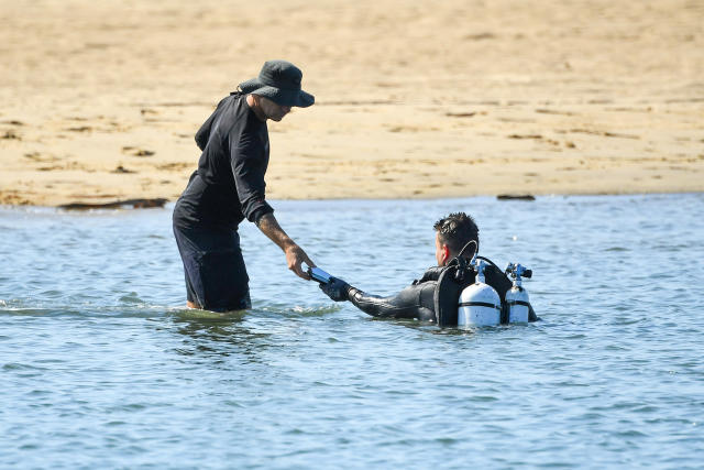 Police divers find debris as they search the Broadwater on the Gold Coast on Tuesday. Source: AAP
