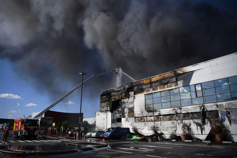 Firefighters work to put out a fire in a building at the Rungis International Market