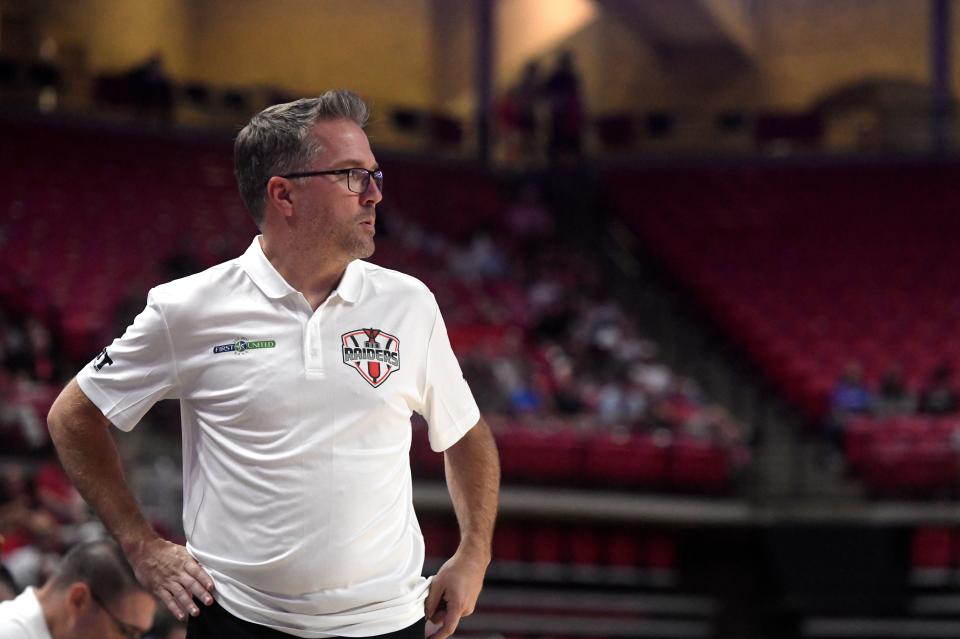 Air Raiders' head basketball coach Jason Staudt speaks to the team during timeout against the Purple Hearts during the first round of The Basketball Tournament Lubbock Regional, Wednesday, July 19, 2023, at United Supermarkets Arena.