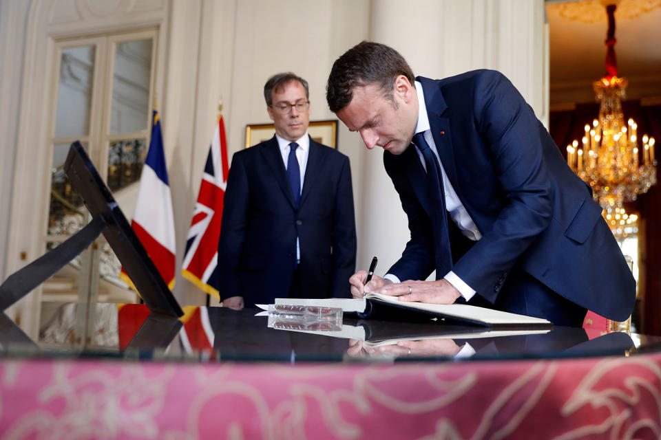 <p>French President Emmanuel Macron (R) signs the book of condolences next to British ambassador Edward Llewellyn (L) at the British Embassy in Paris, France, May 23, 2017, the day after the attack in Manchester. (Etienne Laurent/Pool/Reuters) </p>