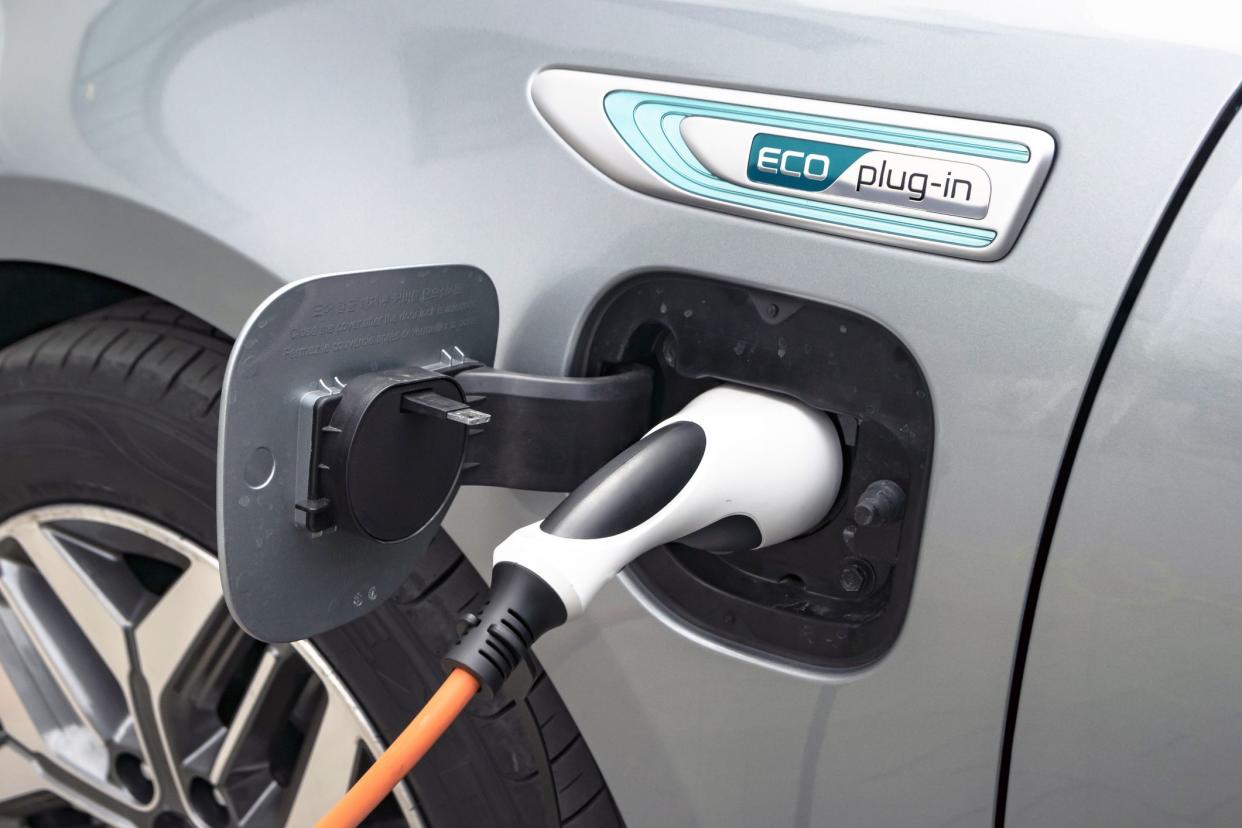 Berlin, Germany - 11 April, 2019: Charging process in Kia Optima plug-in vehicle on the public charging station. This vehicle is on of the first popular sedan vehicles with plug-in hybrid technology in Europe.