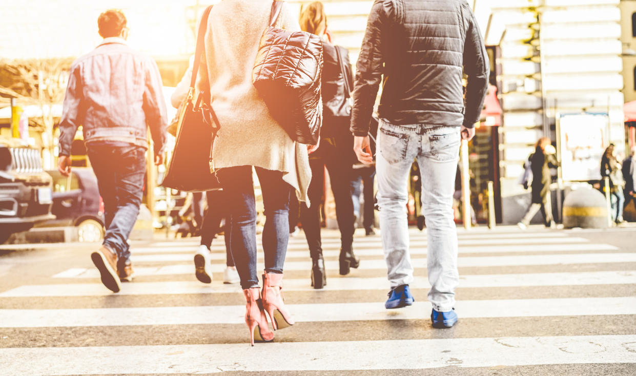 Pictured: Australian workers cross road in busy street. Image: Getty