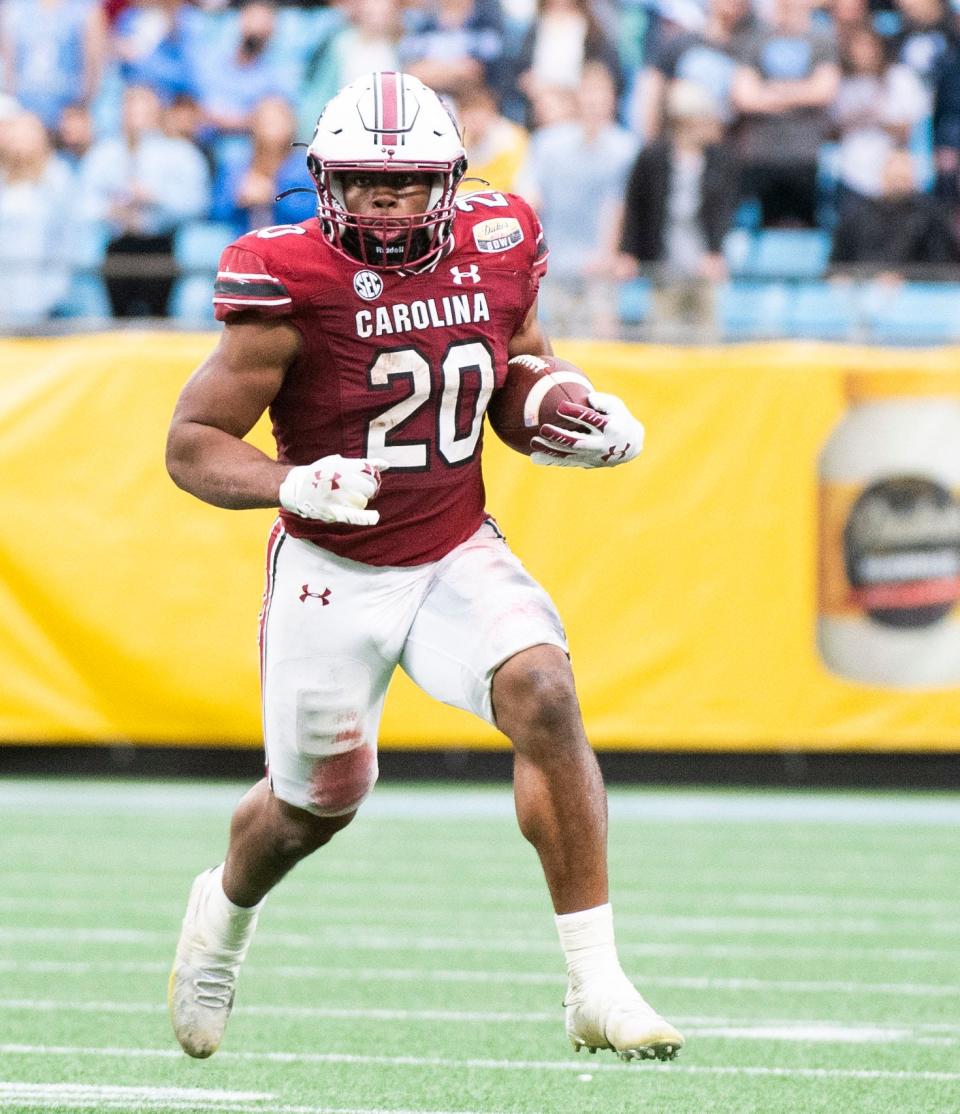 South Carolina Gamecocks running back Kevin Harris (20) takes the ball down the field avoid North Carolina Tar Heels defense during the DukeÕs Mayo Bowl at Bank of America Stadium in Charlotte on Thursday, December 30, 2021.