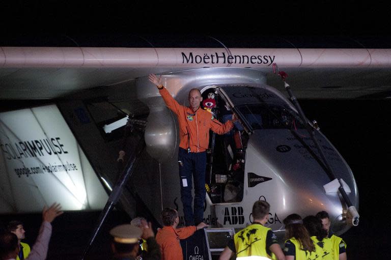 Pilot Bertrand Piccard waves from Solar Impulse 2, the world's only solar powered aircraft, before taking off from Mandalay International Airport in Myanmar on March 30, 2015