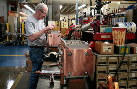 Assembly product worker Ron Leenheer works on the final assembly of a water cooled transformer at RoMan Manufacturing in Grand Rapids, Michigan, U.S. December 12, 2018. Picture taken December 12, 2018. REUTERS/Rebecca Cook