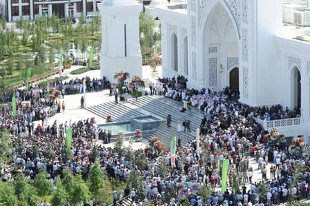 People gather near a new mosque during an inauguration ceremony in Shali