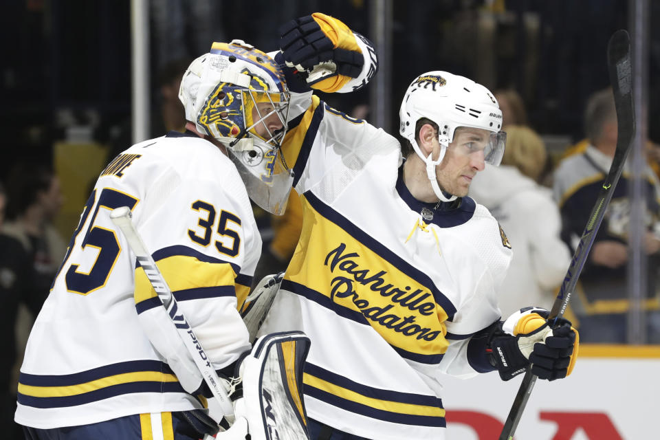 Nashville Predators center Kyle Turris, right, celebrates with goaltender Pekka Rinne (35), of Finland, after the Predators defeated the St. Louis Blues 2-1 in an NHL hockey game Sunday, Feb. 16, 2020, in Nashville, Tenn. (AP Photo/Mark Humphrey)