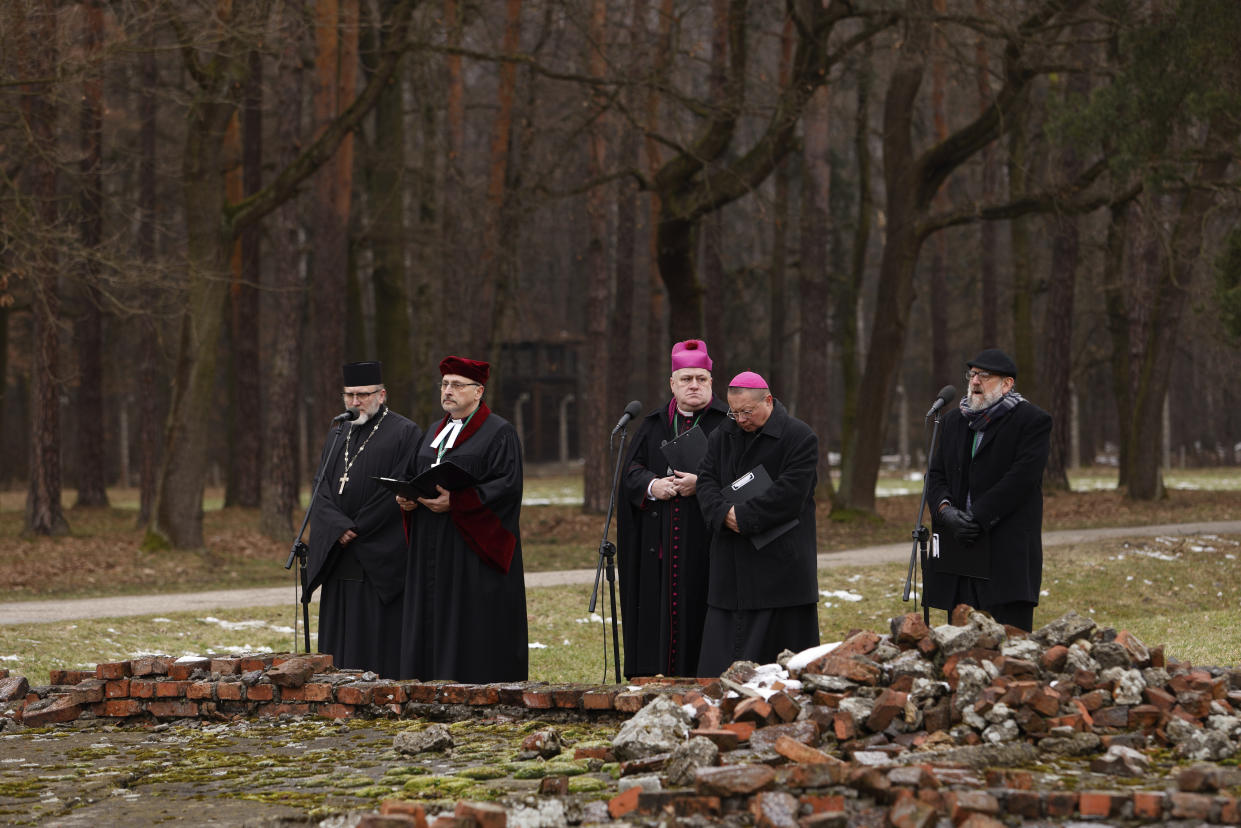 Jewish and Christian clerics pray at the former crematorium during a ceremony in the former Nazi German concentration and extermination camp Auschwitz during ceremonies marking the 78th anniversary of the liberation of the camp in Brzezinka, Poland, Friday, Jan. 27, 2023. (AP Photo/Michal Dyjuk)