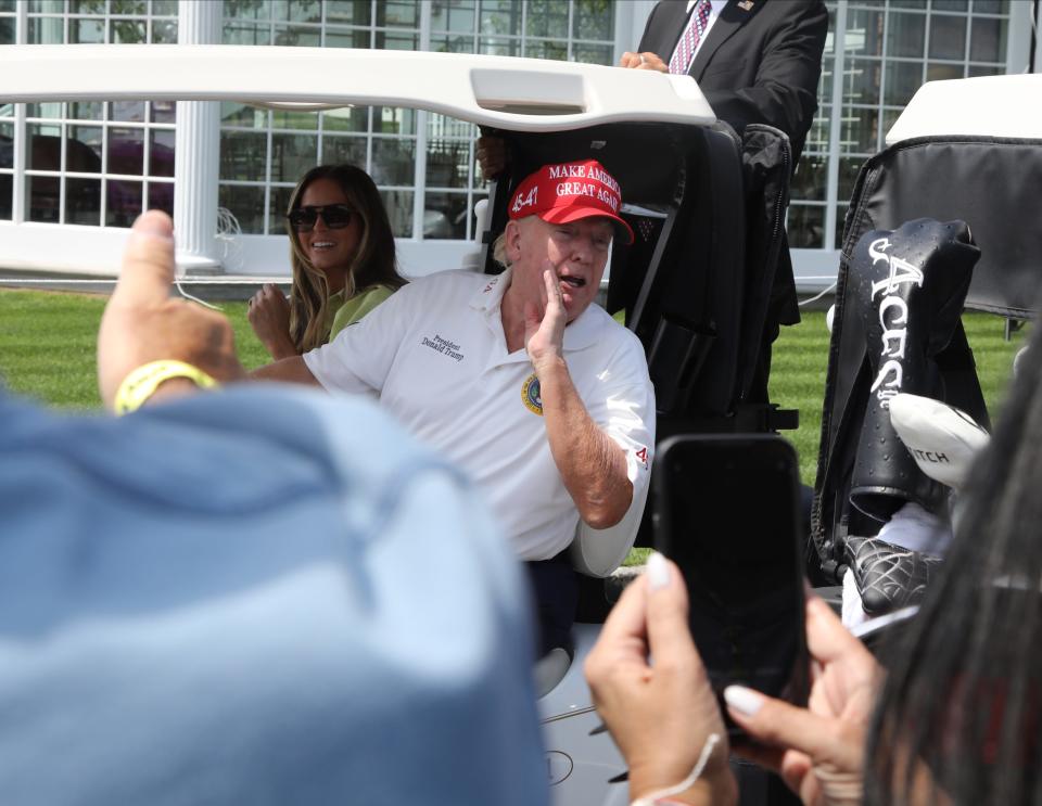 Bedminster, NJ August 11, 2023 -- Trump deputy communications director Margot Martin and former President Donald Trump with fans prior to the opening round of the 2023 LIV Golf Tournament at Trump National in Bedminster, NJ on August 11, 2023.