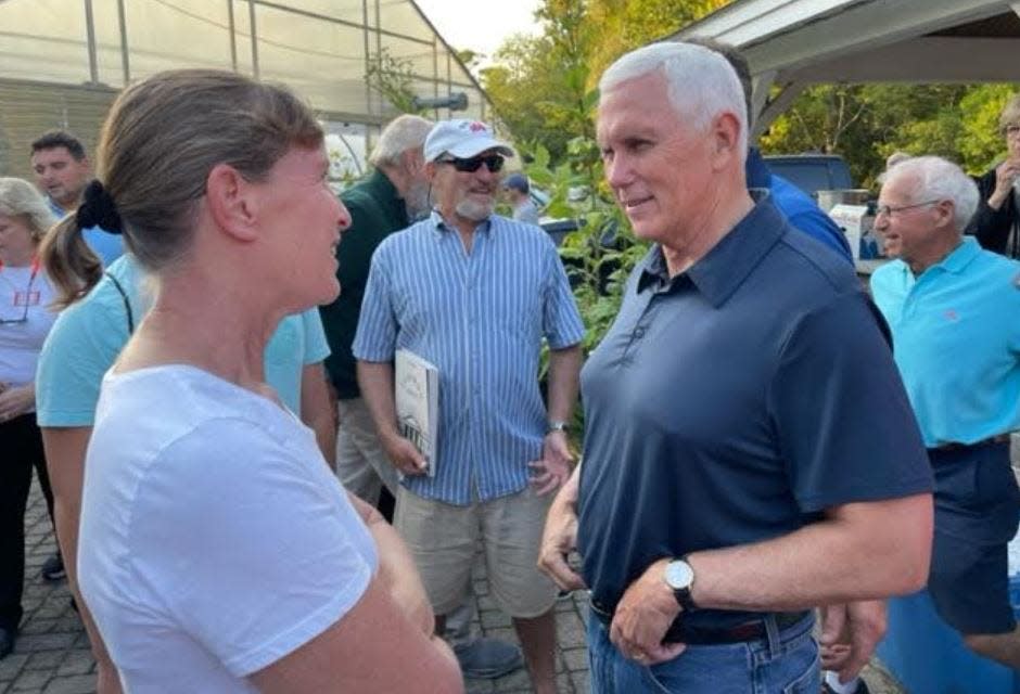 Mike Pence speaks with Amy Borne of Rye on Monday, Sept. 4 at a backyard barbecue hosted by former U.S. senator and ambassador Scott Brown in Rye, NH.