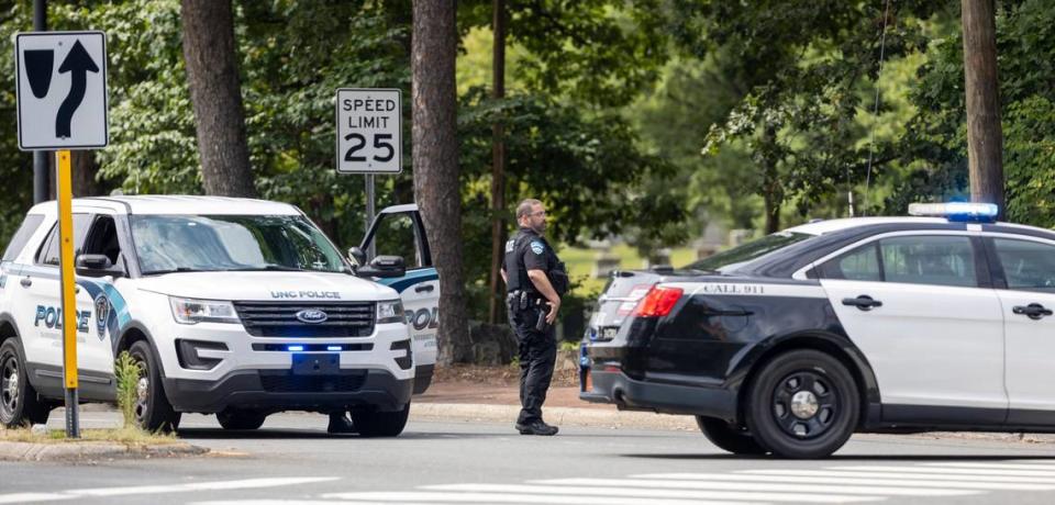 Chapel Hill and University of North Carolina Police departments block South Road at the entrance to the UNC campus as they search for an armed and dangerous person on campus after a reported incident at the student union on Wednesday, September 13, 2023 in Chapel Hill, N.C.