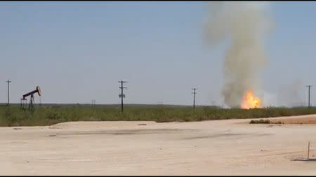 A pipeline explosion erupts in this image captured from video by a field worker in Midland County, the home to the Permian Basin and the largest U.S. oilfield, in Texas, U.S., August 1, 2018. Courtesy Marty Baeza/Handout via REUTERS