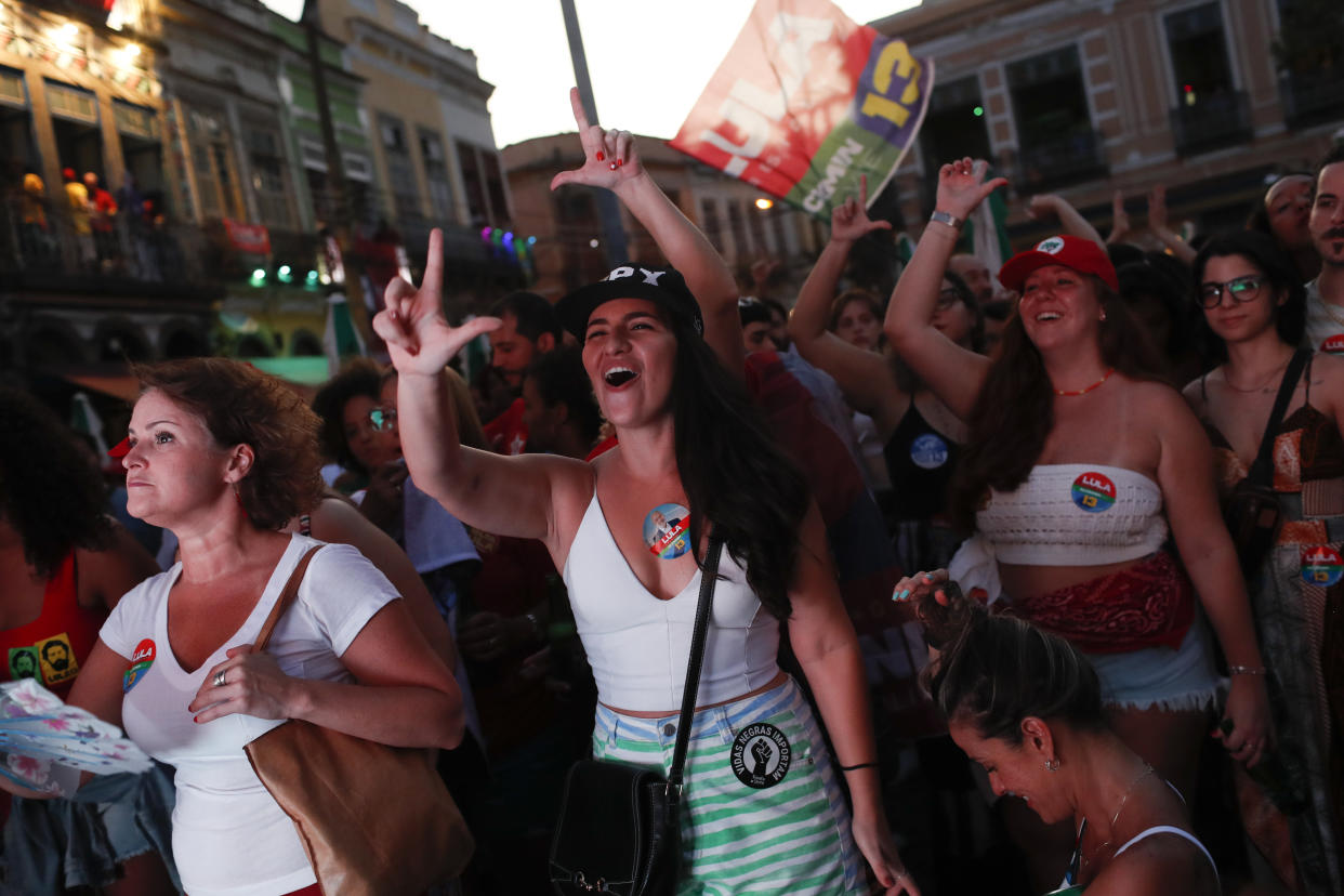 Supporters of Brazil's former President Luiz Inacio Lula da Silva celebrate partial results after polls closed in the country's presidential run-off election, in Rio de Janeiro, Brazil, Sunday, Oct. 30, 2022. On Sunday, Brazilians had to choose between da Silva and incumbent Jair Bolsonaro, after neither got enough support to win outright in the Oct. 2 general election. (AP Photo/Bruna Prado)