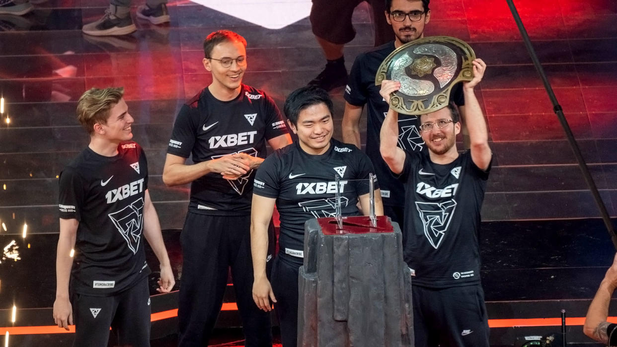 Tundra Esports player 33 lifting the Aegis at TI11