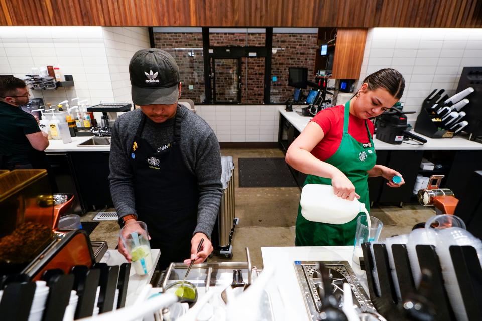 Tryer Lab partners Chan Chan and Emma Parnello, right, make drinks while running a reusable cup test at the Tryer Center at Starbucks headquarters, Wednesday, June 28, 2023, in Seattle. Part of the company's goals is to cut waste, water use and carbon emissions in half by 2030. (AP Photo/Lindsey Wasson)